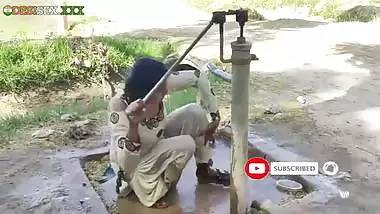 Young village school girl taking a bath in a sari and caught on camera