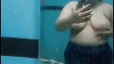 Desi sweet thing touches soft natural breasts in front of a mirror